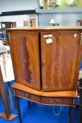 A reproduction cocktail cabinet, dimensions approx H154 W88 D44cm