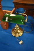 A brass and glass desk lamp