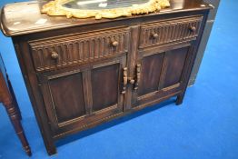 A dark Ercol or similar sideboard, width approx 126cm