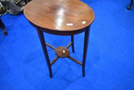 An Edwardian mahogany oval occasional table