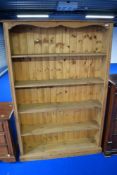 A modern pine bookshelf, approx dimensions H183 W122 D29