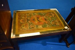 A vintage coffee table having deity decoration, approx 89 x 62cm