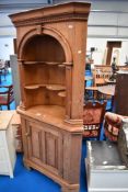 A stripped pine corner shelf with cupboard under , height approx. 200cm