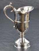 A Queen Elizabeth II silver cream jug, a reproduction of a 17th century ewer of heavy gauge with