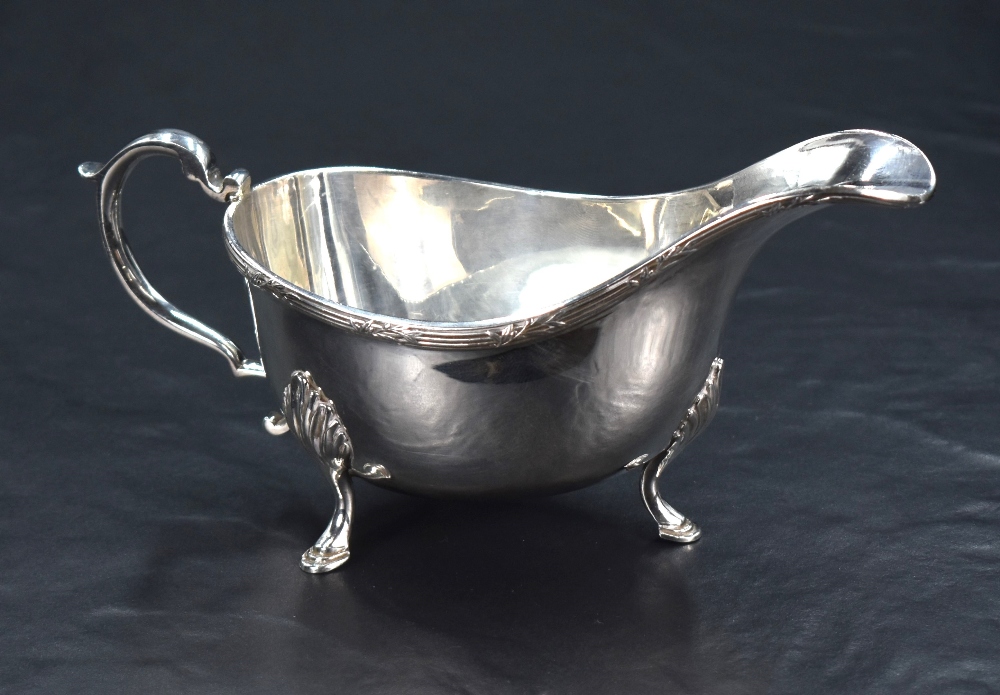 A Queen Elizabeth II silver sauce boat, of traditional form with reeded foliate ornamented rim,