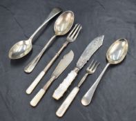 A selection of silver flatware and cutlery comprising a George V silver pickle fork with mother-of-