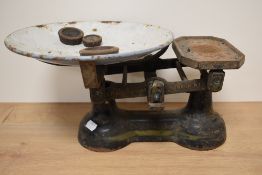 A set of heavy cast metal vintage weighing scales with weights.
