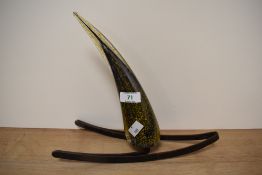 An art glass ornamental centre piece of horn shaped form, of mottled purple and yellow on metal