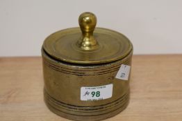 A Victorian brass lidded candy jar, of circular form, measuring 11cm tall