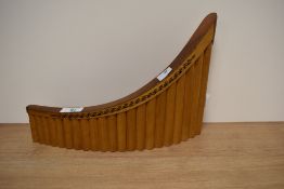 A set of twenty one wooden pan pipes.
