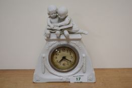 A 20th century white ceramic mantel clock, depicting two young children reading a book to top and
