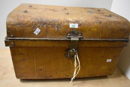 An early 20th Century brown painted tin trunk of domed form, measuring 36cm x 56cm x 34cm overall