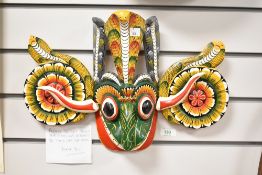 An eye catching and traditional Sri Lankan wooden mask, measuring 43cm wide