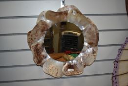 A wall mirror having shell frame.