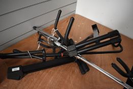 Four guitar stands, various designs