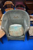 A vintage Lloyd loom tub style arm chair having upholstered seat