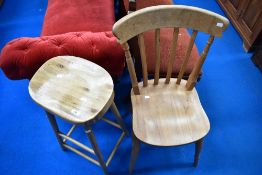 A modern turned wood bar stool and traditional kitchen chair