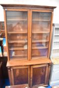 A19th Century mahogany bookcase having glazed top with double cupboard base
