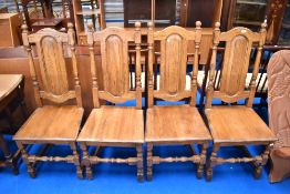 A set of four modern colonial style dining chairs having solid seats and backs