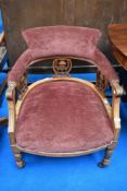 A Victorian salon style low easy chair on turned legs