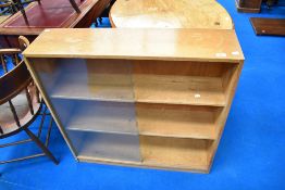 A vintage light oak low bookcase