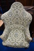 A Queen Anne style wing back armchair having floral upholstery