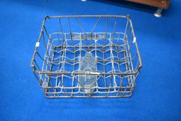 A vintage milk crate , with two bottles