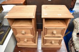 A pair of traditional pine bedside cabinets