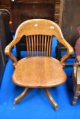 An early 20th Century oak swivel office chair