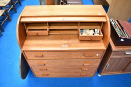 A vintage teak laminate roll top desk