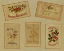 A framed collection of early 20th Century silk embroidered greetings cards, framed, mounted, and