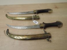 A pair of Turkish/Persian Khanjar Daggers with wood & brass hilts, decorated brass scabbards, 22cm