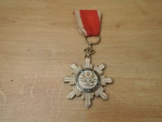 A China, Republic, Order of the Golden Grain, breast badge, in silver, silver-gilt and enamels,