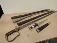A reproduction German Dagger along with an unknown Sword in af condition, two leather scabbards