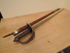A British Infantry Officer's Sword 1895 Pattern with brown leather scabbard, decorated blade,