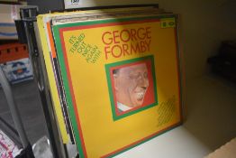 A selection of vintage record albums including George Formby, Max Boyce and the Goon Show etc.