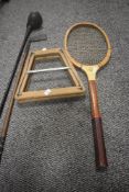 Two vintage wood handled golf clubs and a wooden tennis racquet with stretcher.