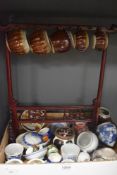 A selection of oriental ceramics,including tea bowls, and miniature cups, some of which are housed
