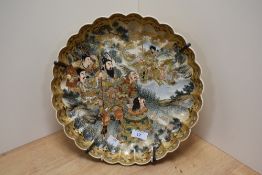 An early 20th century Japanese Satsuma pottery charger, of fluted and lobed circular form