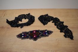 An Art Deco beaded applique and a two piece garter set