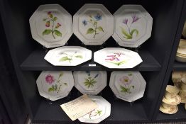 A group of nine Limoges porcelain plates, of octagonal form, decorated with floral studies, diameter