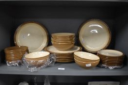 A collection of Denby stonware tableware, in a brown glaze, and including bowls, dinner plates,
