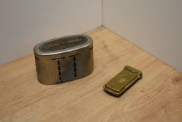 A vintage District Bank money box and a Victorian brass needle case.