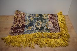 An early 20th Century silk embroidered and tasselled table cloth, of Moorish design, measuring 115cm