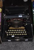 A 1932 Corona folding typewriter in original box.