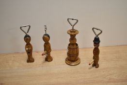 A group of four vintage novelty/risqué olive wood bottle openers