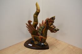 An attractive carved and hand-decorated Balinese dragon, mounted to a sheild from oak plaque.