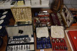 A selection of boxed desert spoons, fish knife and forks, teaspoons and a small quantity of