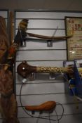 An unusual selection of tribal items to include a flint pick, wooden club hammer, a wall mask and