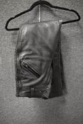 A pair of ladies JTS Biker Clothing XS leather padded motor cycle trousers.